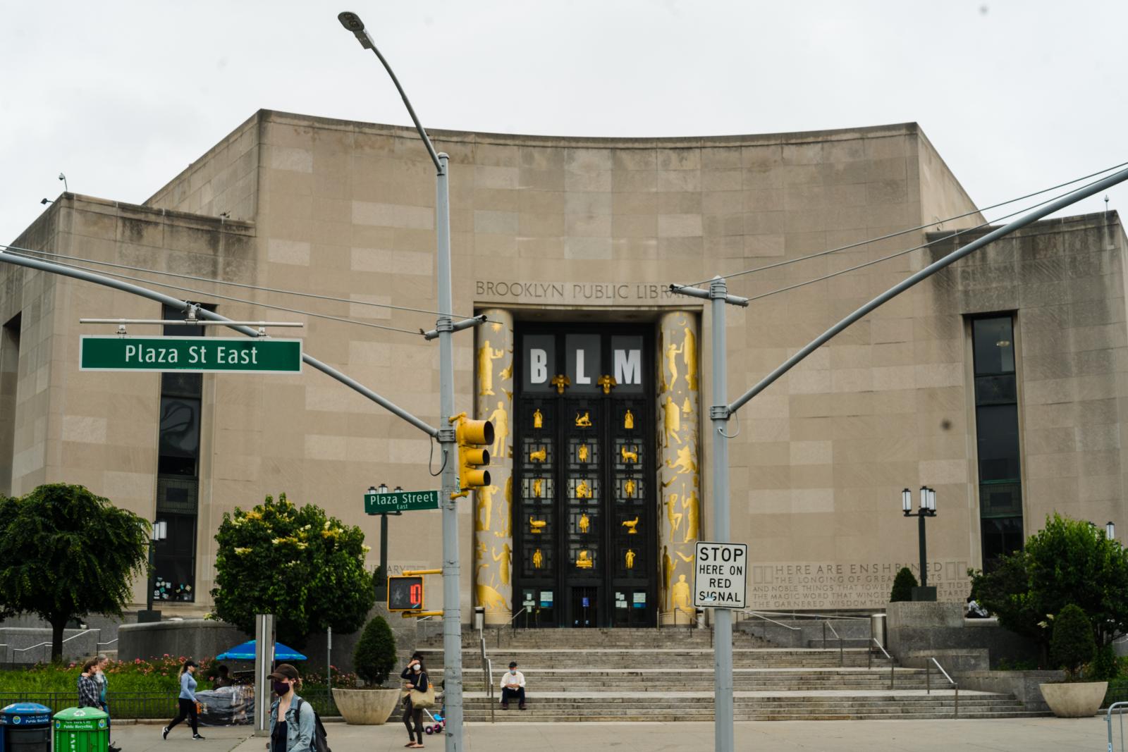 photo of Brooklyn Public Library's central branch with BLM in large letters over the doors